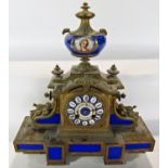 A Victorian gilt brass and porcelain panelled mantel clock with eight day striking movement
