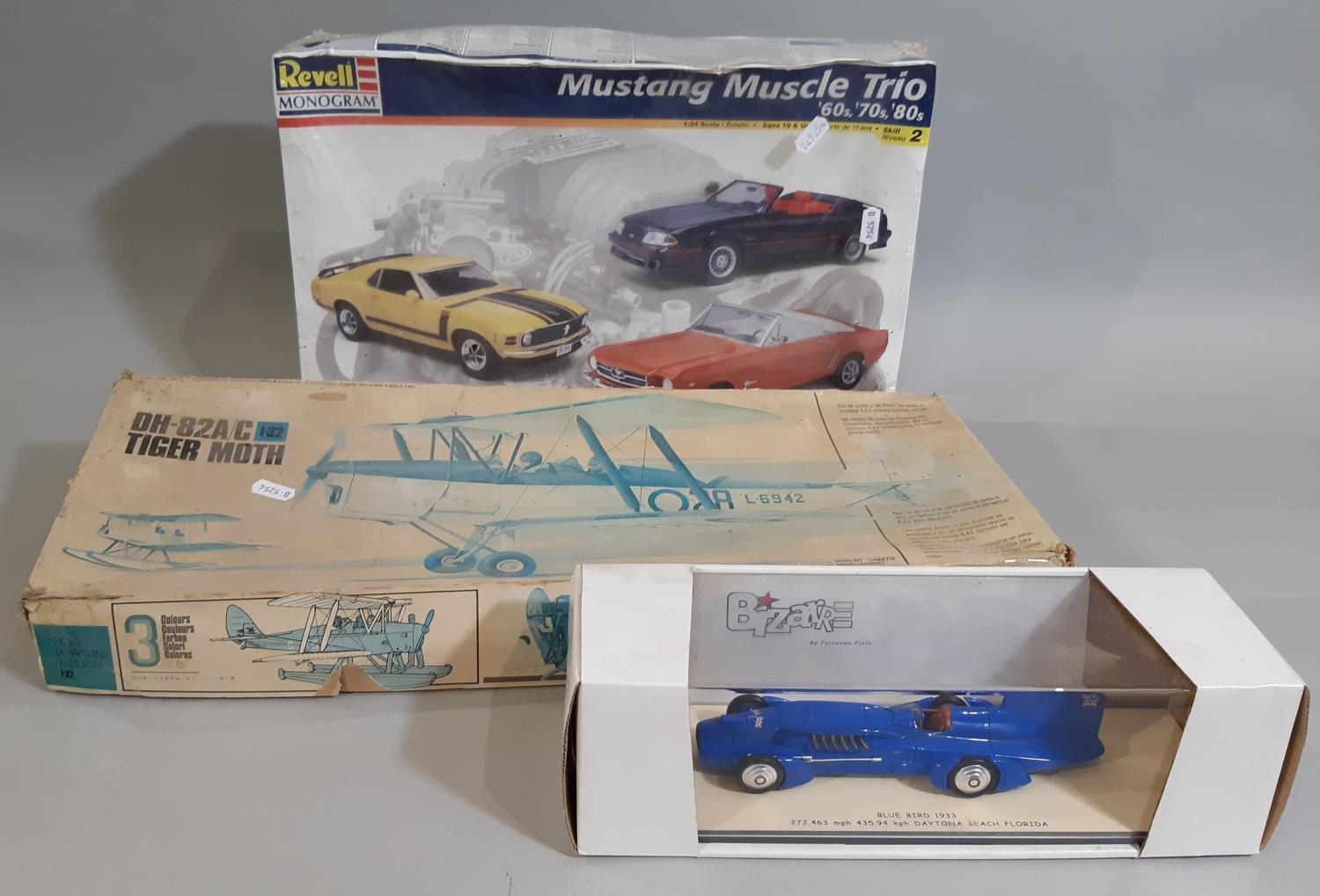 3 boxed models; Mustang Muscle Trio by Revell 1:24 scale, a 'Bluebird 1933' model racing car 1:43