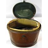 An oval tin hat box containing one pair of athletes running spikes and one pair of vintage