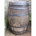 A weathered coopered oak and steel banded beer or cider barrel 98 cm high (af)