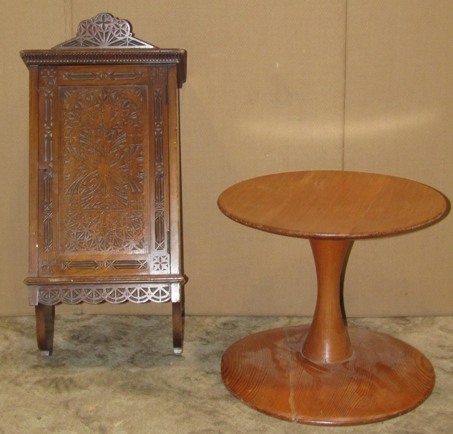 A small walnut hanging wall cabinet enclosed by a single rectangular panelled door with chip