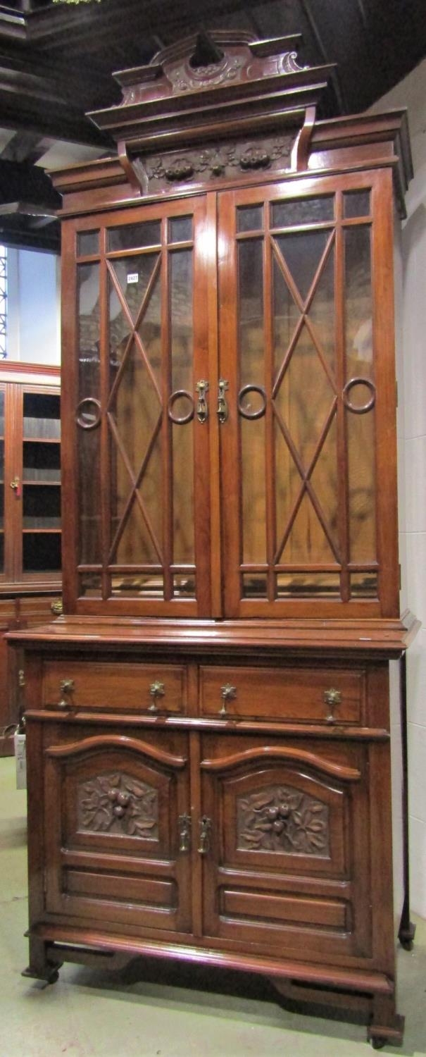 A good quality Edwardian walnut dresser with carved fruiting vine detail enclosed by four doors