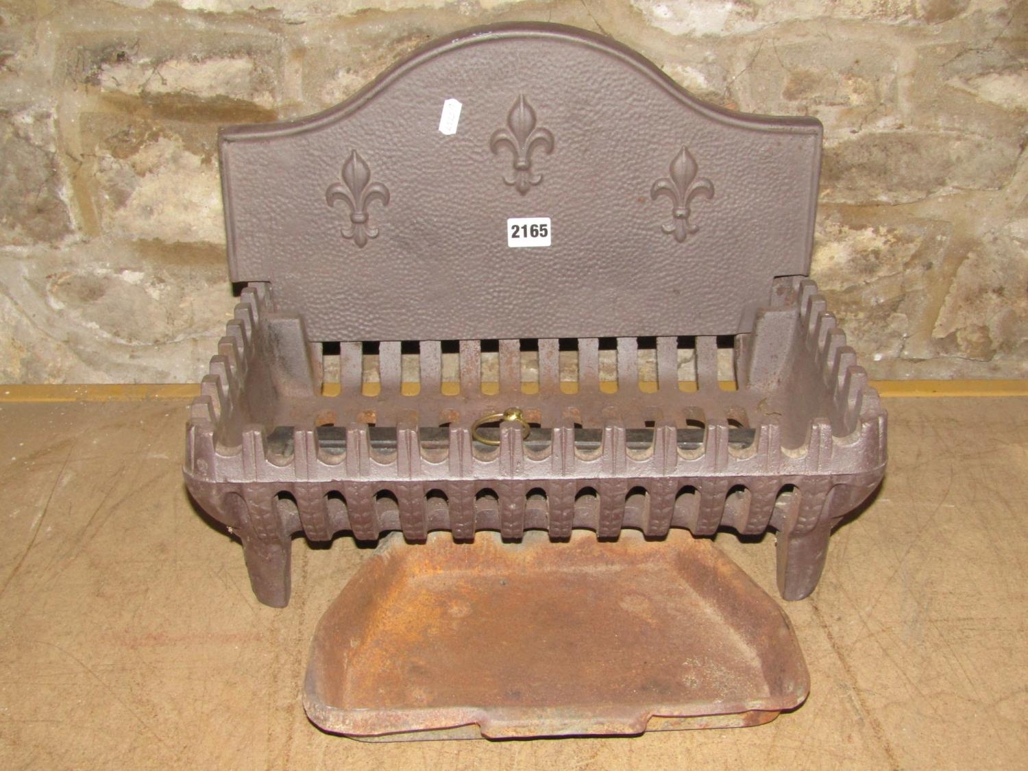 A small cast iron fire basket of rectangular form with removable arched back with fleur-de-lys