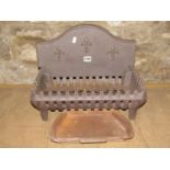 A small cast iron fire basket of rectangular form with removable arched back with fleur-de-lys