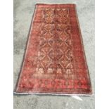 A North East Persian Turkoman rug with double rows of elephant foot medallions in tone of pink and