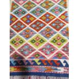 A Chobi kilim runner with a multi colour small diamond pattern, 197cm x 66cm approx.