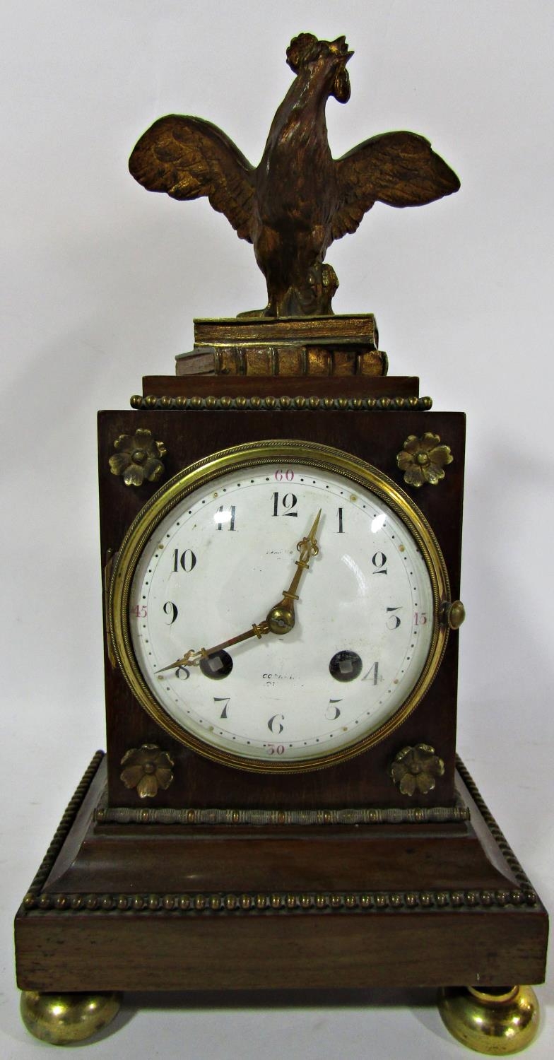 A 19th century French mantel clock, the timber case with applied brass mounts surmounted by a