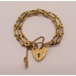 9ct twisted gate link bracelet with engraved heart padlock clasp and Welsh love spoon charm, 12.6g