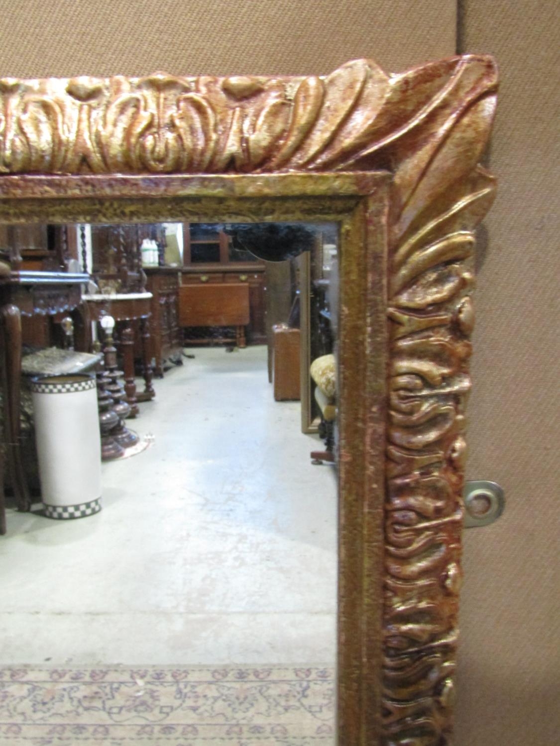 A rectangular gilt framed wall mirror with repeating foliate detail 86 cm x 55 cm - Image 2 of 2