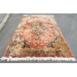 A modern Middle Eastern carpet with on overall floral pattern in pink and pale blue tones, 277cm x