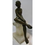 A classical bronze statue of Aphrodite adjusting her sandal mounted on a marble plinth, 18cm