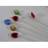 Nine Murano style glass cocktail twizzle sticks with colourful pasta shell tops and a single