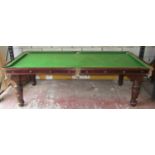 A late 19th century mahogany snooker table/dining table, the slate base raised on four turned and