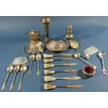 An assortment of english hallmarked silver to include a pepper pot, ashtray, sherry ladle,