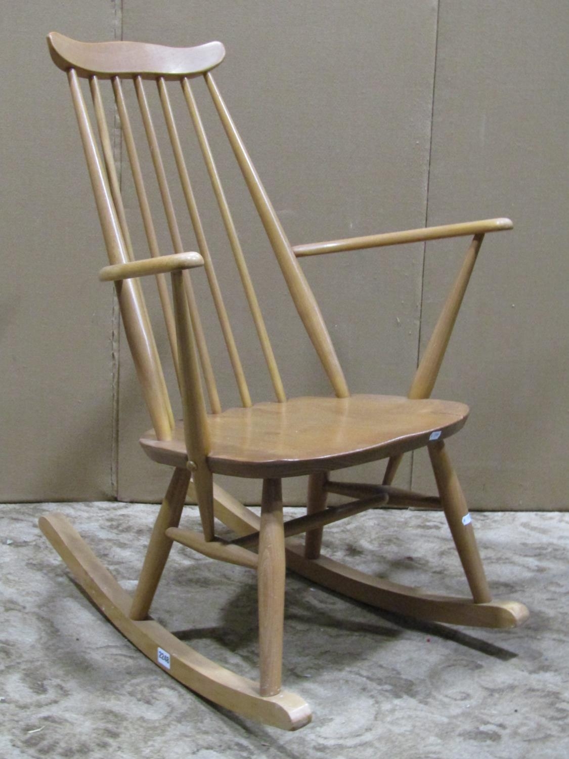 A vintage light elm and beechwood stick back rocking chair