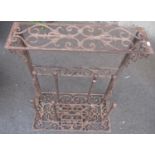A weathered contemporary cast iron boot stand with decorative pierced scrollwork detail, 64 cm
