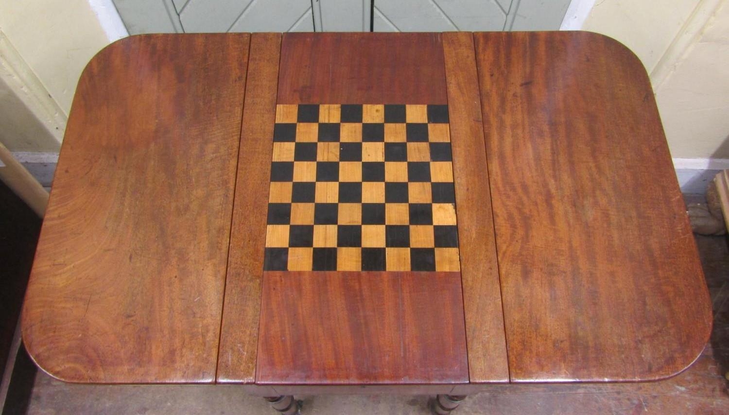 A 19th century mahogany drop leaf games table, the sliding and convertible top enclosing a chequer - Image 2 of 2