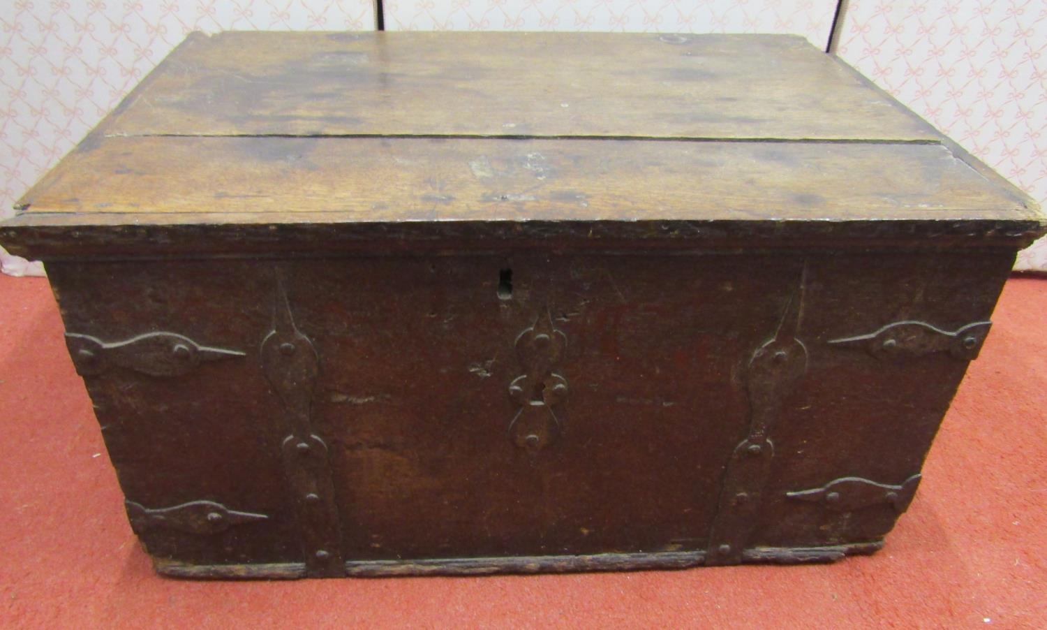 An early oak and iron bound strong box with carrying handles, 64cm wide x 43cm deep x 33cm high