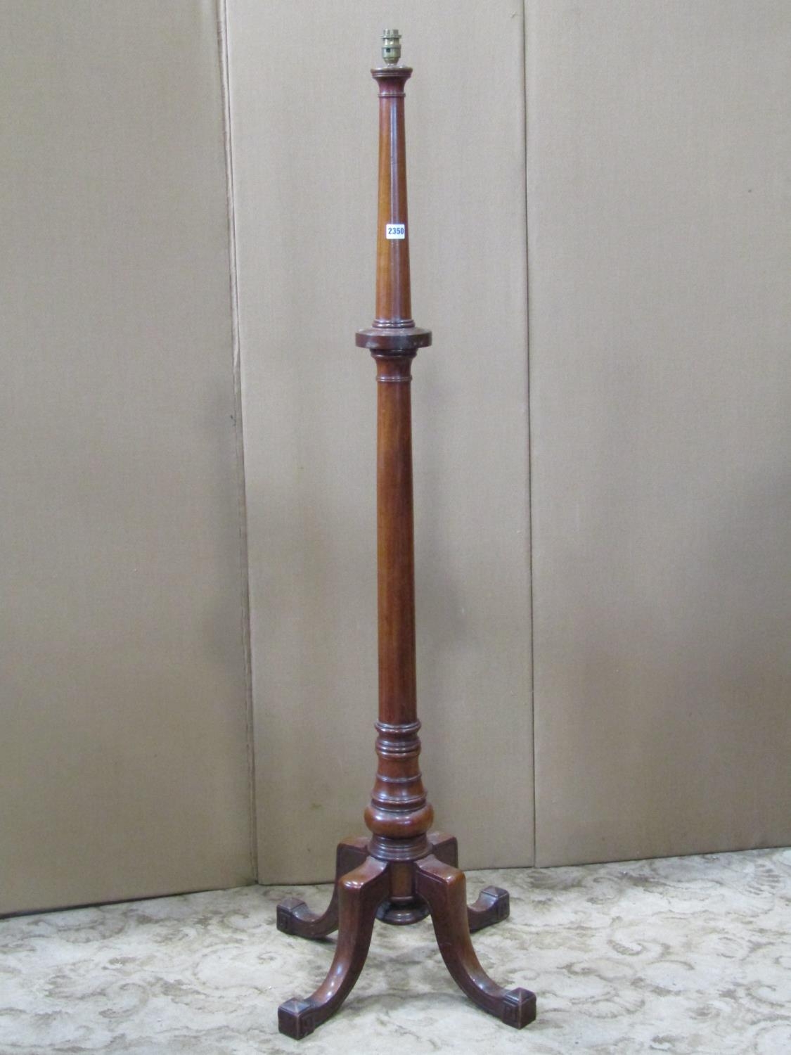 A turned mahogany standard lamp raised on swept quadruped supports, 161 cm (full height)