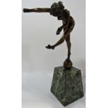 An early 20th century bronze naked female acrobat balancing balls on her hands and left foot,