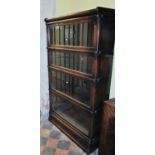 A four tier Globe Wernicke oak framed sectional bookcase with glazed up and over doors and one