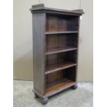 A small reproduction mahogany freestanding open bookcase with pierced fretwork gallery 59cm w x 22cm