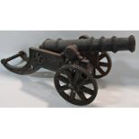 A 19th century cast iron miniature field canon 48cm wide.