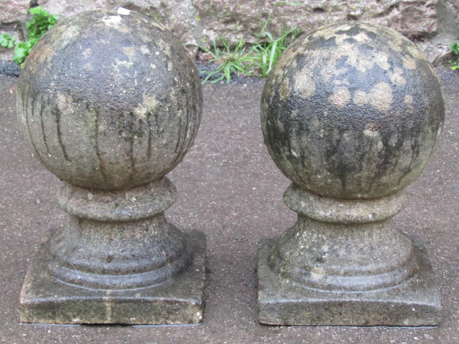 A pair of small weathered cast composition stone sphere pier cap finials approx 20 cm diameter x
