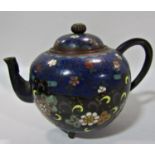 A small Japanese cloisonné round teapot with overall floral decoration on a tripod base. 10.5cm