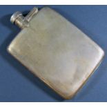 A silver Engine turned flat hip flask with a screw top lever stopper, 9cm long, to hold 5/16ths of a