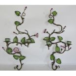 A pair of brass and china candle wall sconces with pink flowers and green vine leaves each with
