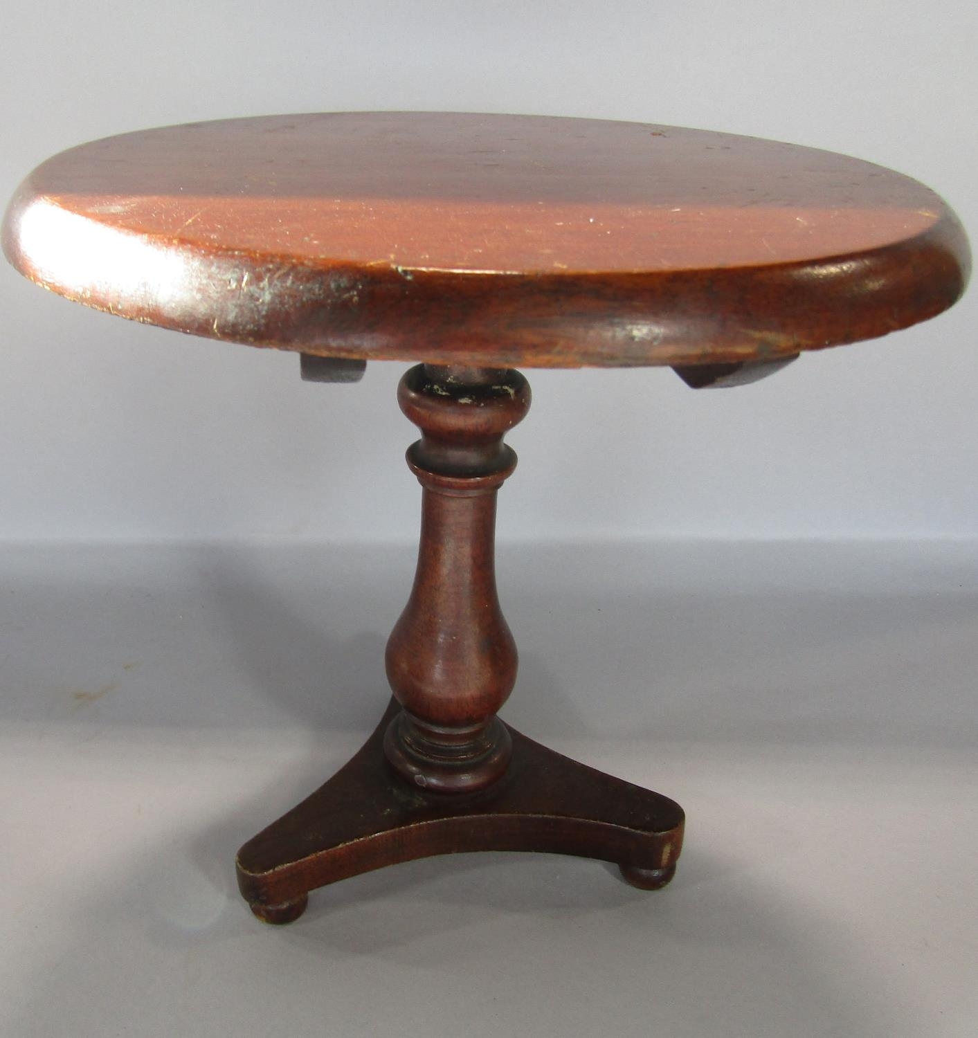 An apprentice piece Georgian style mahogany circular tilt top tripod table.