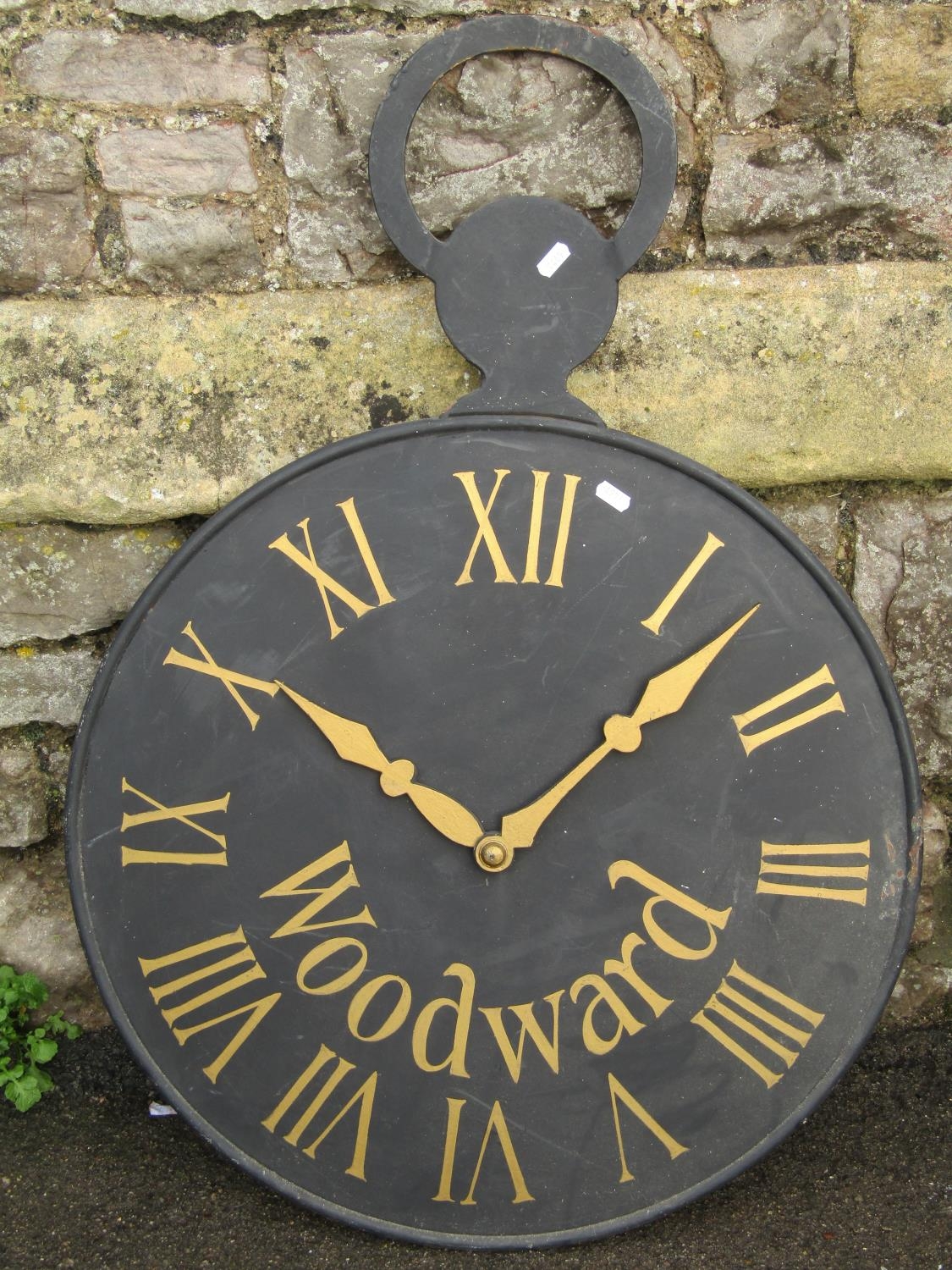 A decorative double sided cast iron sign, in the form of an outsized pocket watch, 62 cm diameter