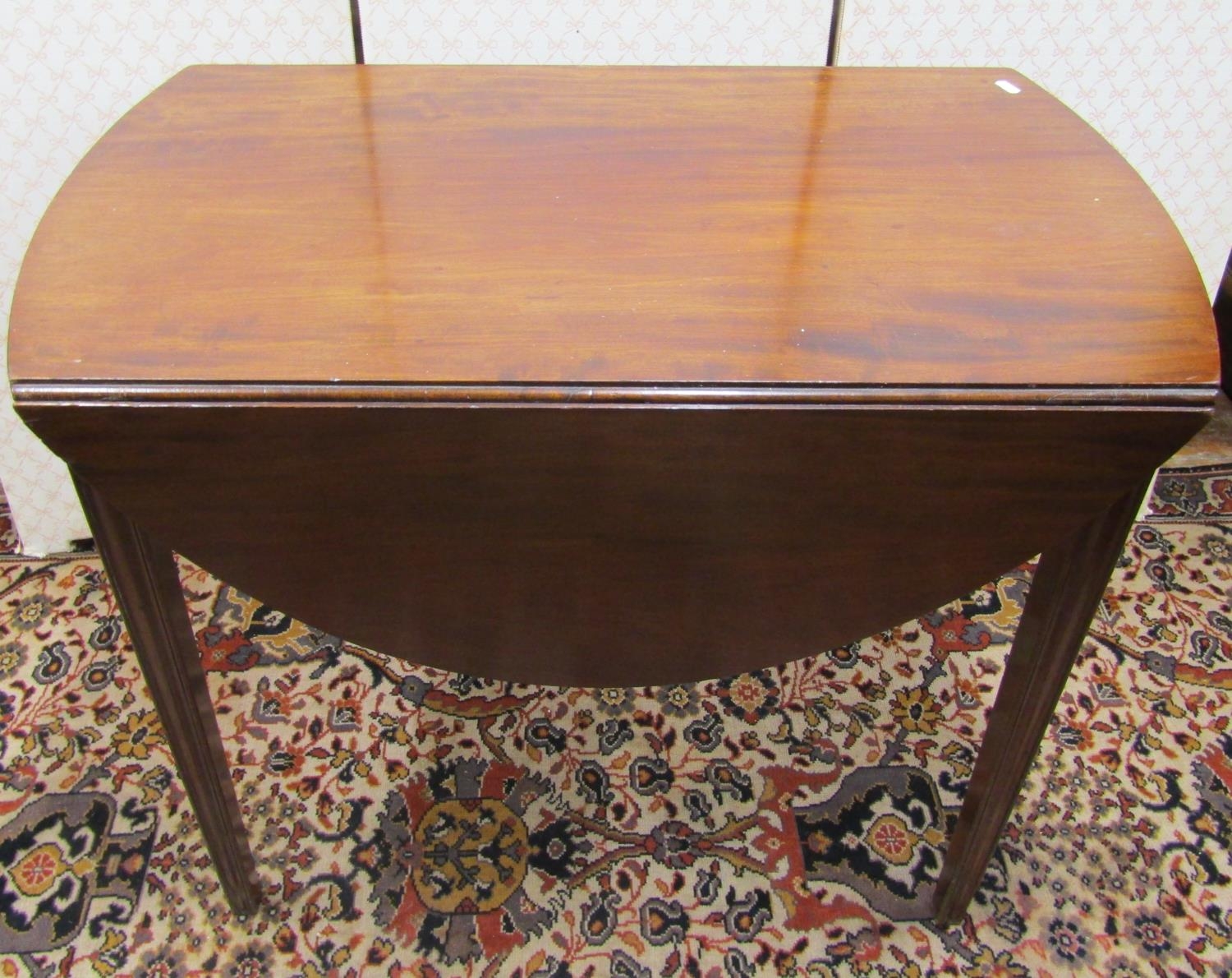 A 19th century mahogany oval Pembroke table with frieze drawer raised on square tapered supports