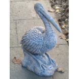 A composite garden ornament in the form of a stork sat on a naturalistic rocky outcrop 58 cm high