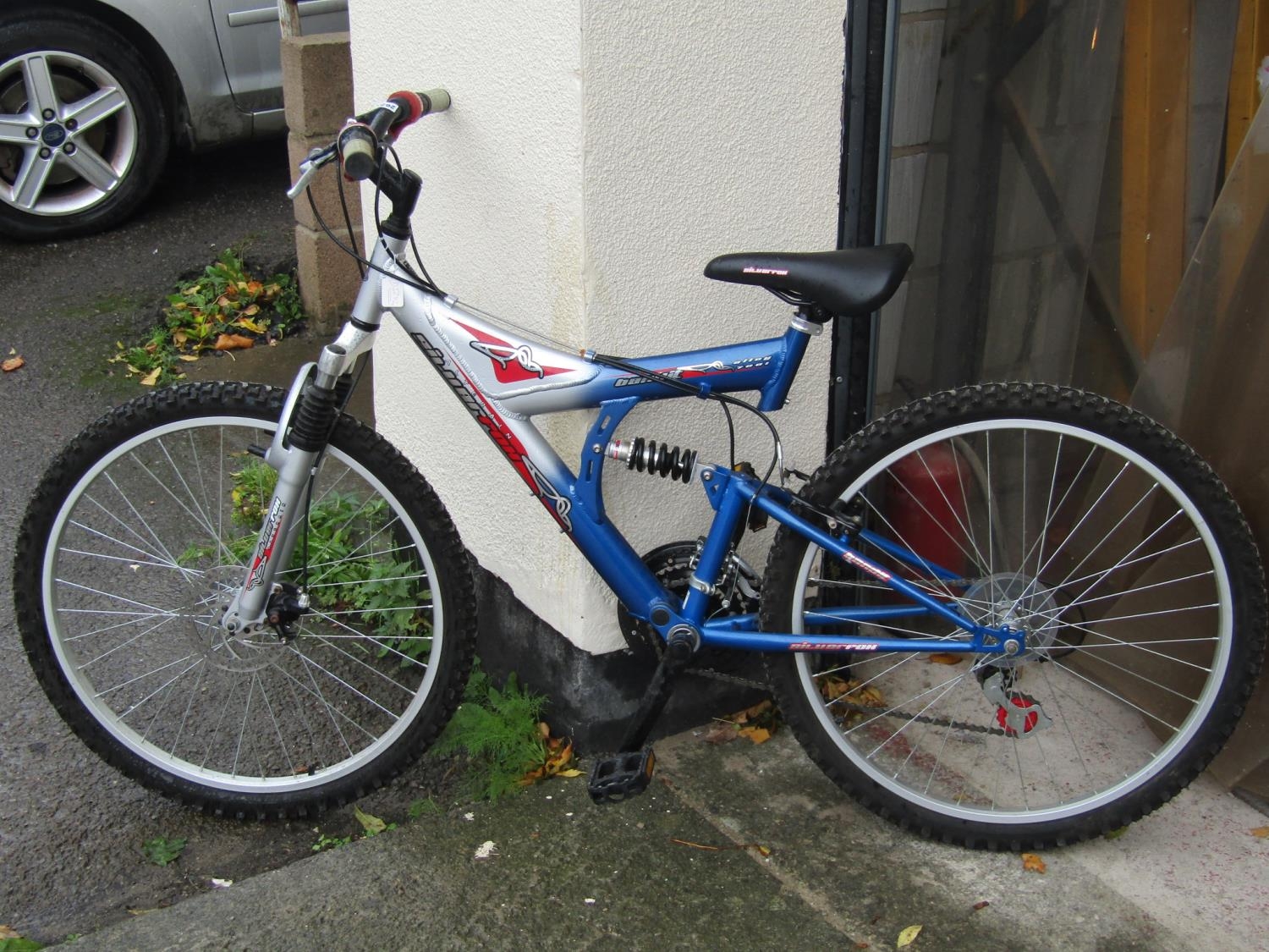 A silver Bandit all terrain mountain bike with grip shift gearing (almost new, unused gift)