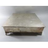 A square silver plated ornamental cake stand raised on scrolled supports, 42cm.
