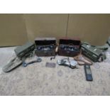 Four metal cased military field telephones and a miscellaneous collection of headsets, hand sets,