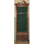 An Edwardian mahogany gun cabinet floorstanding and enclosed by a three quarter length rectangular