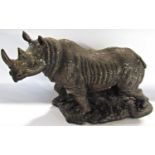 A bronze resin statue of a rhinoceros, signed B H Hollinger, 50cm wide approx