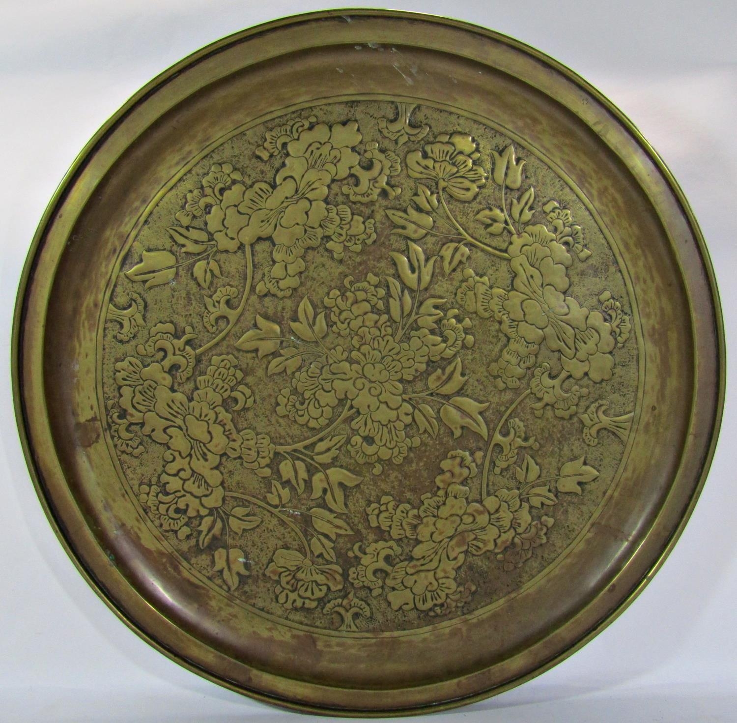 A 19th century KSIA (Keswick School of Industrial Arts) large brass floral embossed charger, 63cm