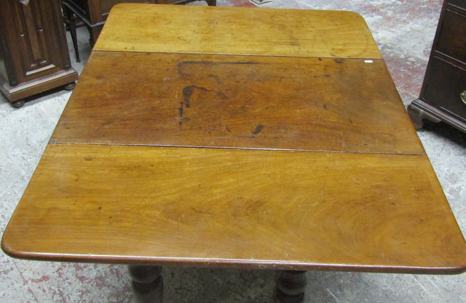 A 19th century mahogany drop leaf dining table on four turned supports, the top with swivel action - Image 4 of 6