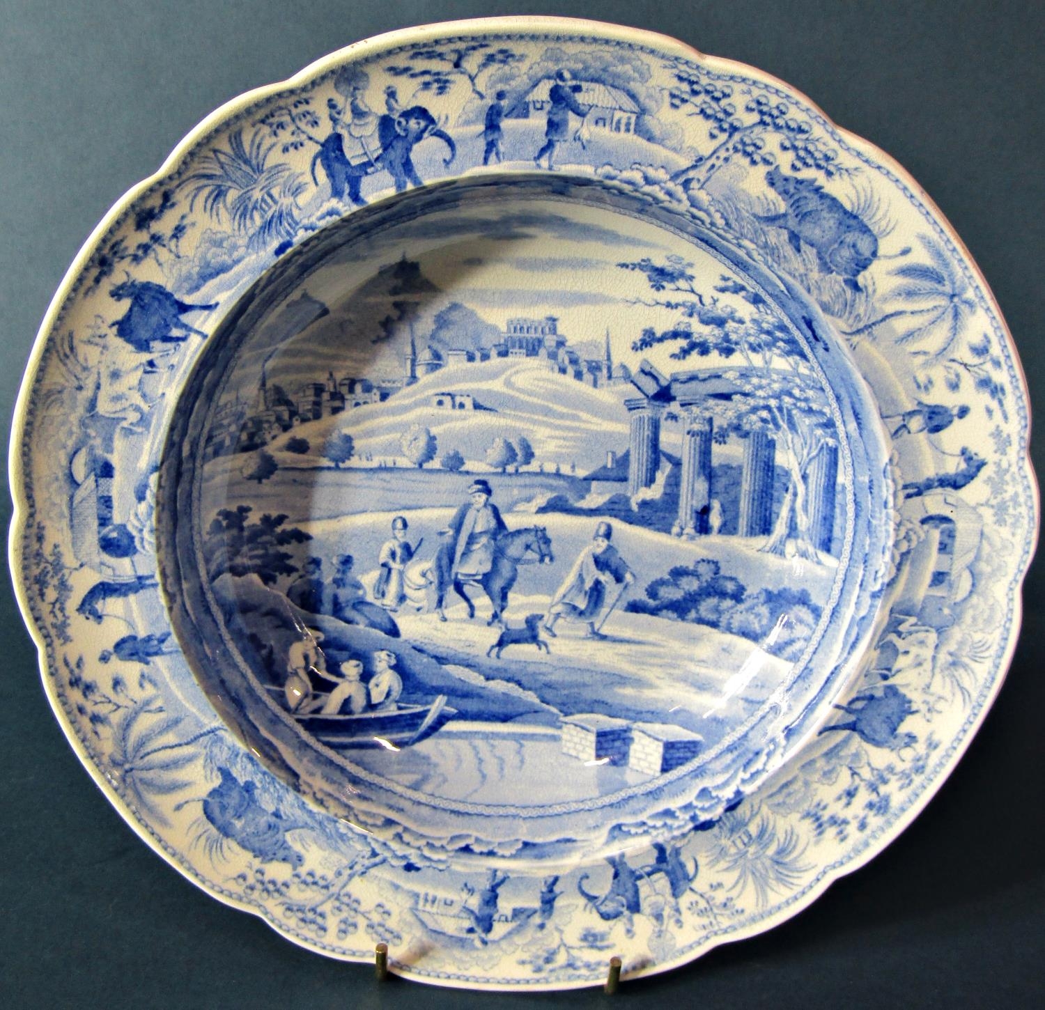 A 19th century blue and white transfer ware plate by Rogers showing a Giraffe and characters in a