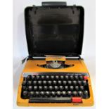 A brother Deluxe 250TR vintage typewriter in an orange colourway