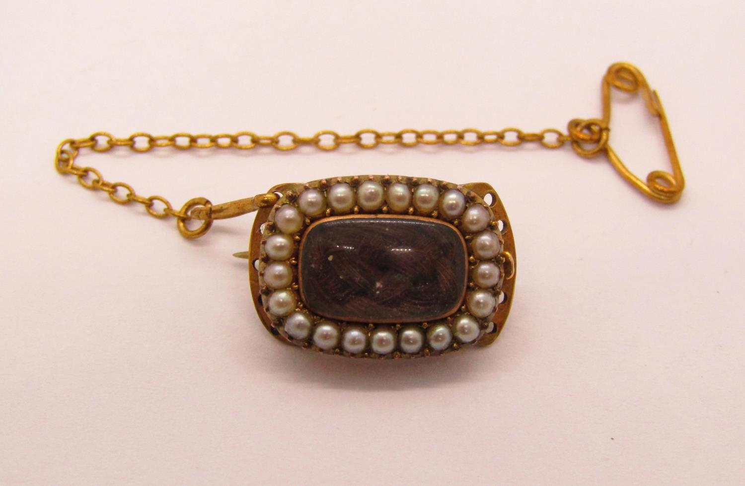 Georgian yellow metal mourning clasp containing plaited hair within seed pearl surround,