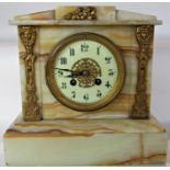 A Victorian onyx mantel clock with applied gilt mounts containing an eight day striking movement