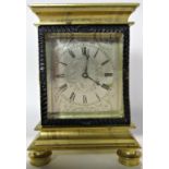 A late Georgian mantel clock the rectangular engraved silvered dial with scrolling flowers, to the