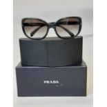 One pair ladies sunglasses by Prada, unused with original hard case, sealed cleaning cloth and