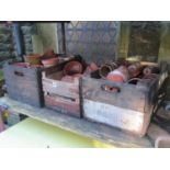 Three vintage wooden crates containing a quantity of terracotta flower pots of varying size