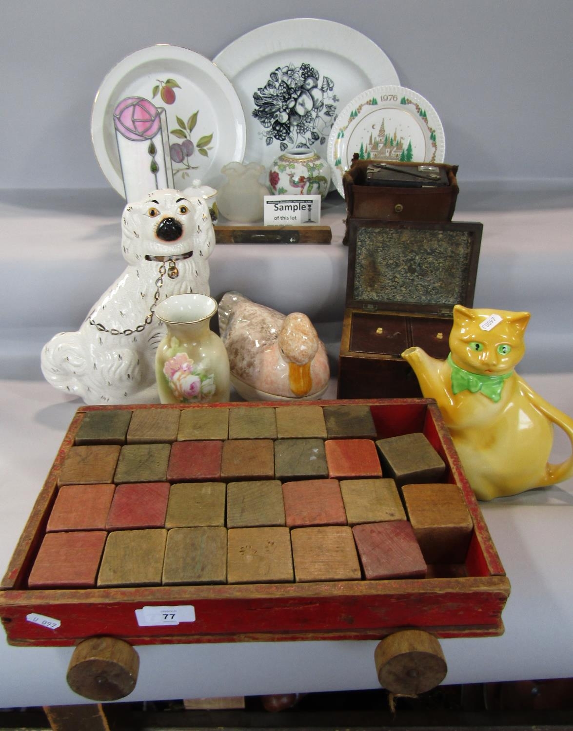 A miscellaneous collection of items including a pair of Staffordshire style spaniels, a cat